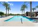 Large community pool with palm trees, shade and lounge chairs at 21716 S 225Th Way, Queen Creek, AZ 85142