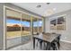 Cozy dining area with a modern chandelier and sliding glass doors to the backyard at 21716 S 225Th Way, Queen Creek, AZ 85142