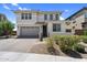 Charming two-story home with a two-car garage and a welcoming front entrance at 21716 S 225Th Way, Queen Creek, AZ 85142