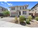 Charming two-story home with a gray garage door exhibits beautiful desert landscaping and appealing exterior elevation at 21716 S 225Th Way, Queen Creek, AZ 85142