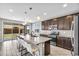 Modern kitchen with granite countertops, stainless steel appliances, and a large center island at 21716 S 225Th Way, Queen Creek, AZ 85142