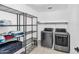 Convenient laundry room with shelving and modern washer and dryer units at 21716 S 225Th Way, Queen Creek, AZ 85142