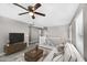 Staged living room with a ceiling fan, modern furniture and bright natural light at 21716 S 225Th Way, Queen Creek, AZ 85142