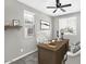 Cozy home office with modern desk, chair and two windows for natural light at 21716 S 225Th Way, Queen Creek, AZ 85142