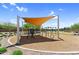 Community playground with a covered swing structure and other play equipment at 21716 S 225Th Way, Queen Creek, AZ 85142