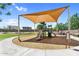 Community playground with a large shade structure with slides and climbing apparatus at 21716 S 225Th Way, Queen Creek, AZ 85142