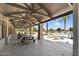 Community pool area featuring shaded picnic tables, lounge chairs and towering palm trees at 21716 S 225Th Way, Queen Creek, AZ 85142