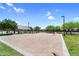 Community sand volleyball court surrounded by lush green grass and mature trees at 21716 S 225Th Way, Queen Creek, AZ 85142