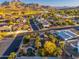 Aerial view of desert neighborhood with pools, mature trees, and mountain views at 2712 E Mountain View Rd, Phoenix, AZ 85028