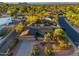 Aerial view of a charming neighborhood featuring mature trees, lush landscaping, and a sparkling community pool at 2712 E Mountain View Rd, Phoenix, AZ 85028