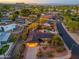 Beautiful Scottsdale neighborhood aerial view featuring mountain views at sunset and a home with lush desert landscaping at 2712 E Mountain View Rd, Phoenix, AZ 85028