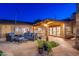 Inviting back patio featuring stylish seating, flagstone pavers, and a charming pergola with integrated lighting at 2712 E Mountain View Rd, Phoenix, AZ 85028