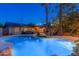Inviting backyard featuring a sparkling pool, covered patio, lush landscaping, and ample space for outdoor gatherings at 2712 E Mountain View Rd, Phoenix, AZ 85028