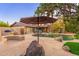 Expansive backyard with stone patio, pool, and outdoor seating, perfect for entertaining guests and enjoying the outdoors at 2712 E Mountain View Rd, Phoenix, AZ 85028