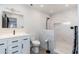 Modern bathroom with marble walk-in shower, white vanity, and contemporary fixtures at 2712 E Mountain View Rd, Phoenix, AZ 85028