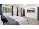 Modern bedroom featuring a gray bed, tile floors, and a mounted television at 2712 E Mountain View Rd, Phoenix, AZ 85028