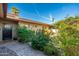 Front exterior featuring lush landscaping, a stone walkway, and a welcoming entrance at 2712 E Mountain View Rd, Phoenix, AZ 85028