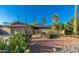 Desert home with cacti, gravel, rock and mature palm trees under a bright blue sky at 2712 E Mountain View Rd, Phoenix, AZ 85028