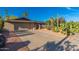 Driveway leading to the home with desert landscaping including cacti, gravel, rock and mature palm trees at 2712 E Mountain View Rd, Phoenix, AZ 85028