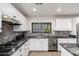 Detailed view of kitchen featuring stainless steel appliances, white cabinets, and granite countertops at 2712 E Mountain View Rd, Phoenix, AZ 85028