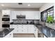 Bright kitchen with white cabinets, granite countertops, stainless steel appliances, and stone backsplash at 2712 E Mountain View Rd, Phoenix, AZ 85028