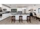 Well-lit kitchen features white cabinetry, granite countertops, an island with bar stools, and stainless steel appliances at 2712 E Mountain View Rd, Phoenix, AZ 85028