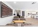 Stylish living room showcasing tile flooring, neutral paint, modern furniture and decor, plus a view of the open kitchen at 2712 E Mountain View Rd, Phoenix, AZ 85028