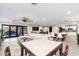 Spacious open-concept living area with tile floors, neutral colors, and a view of the kitchen at 2712 E Mountain View Rd, Phoenix, AZ 85028