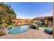 Spacious backyard with pool, waterfall feature, outdoor fireplace, grill, and patio seating area at 2712 E Mountain View Rd, Phoenix, AZ 85028