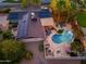 Aerial view of the backyard oasis, featuring a kidney-shaped pool and solar panels at 2712 E Mountain View Rd, Phoenix, AZ 85028