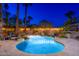 Stunning outdoor area with a sparkling pool, lush trees, waterfall feature and inviting patio area for relaxation at 2712 E Mountain View Rd, Phoenix, AZ 85028
