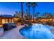 Stunning backyard pool with palm trees, waterfall feature and cozy seating area, perfect for relaxation and entertaining at 2712 E Mountain View Rd, Phoenix, AZ 85028