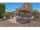 View of the backyard of the house, showcasing the patio, lounge seating, and outdoor cooking space at 2784 E Honeysuckle Pl, Chandler, AZ 85286