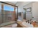 Well-lit bathroom with shower featuring glass door, tiled walls, and modern fixtures for a serene bathing experience at 2784 E Honeysuckle Pl, Chandler, AZ 85286