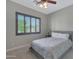 Neutral bedroom with plush carpet, a ceiling fan, and a large window with backyard view at 2784 E Honeysuckle Pl, Chandler, AZ 85286