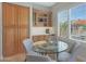Cozy breakfast nook featuring a glass table, upholstered chairs, and storage cabinets with a built in hutch at 2784 E Honeysuckle Pl, Chandler, AZ 85286