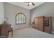 Bright living room with arched window, custom shutters, and built-in cabinet at 2784 E Honeysuckle Pl, Chandler, AZ 85286