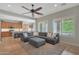 Inviting living room featuring a comfortable gray sectional sofa, ceiling fan, and an open view to the kitchen at 2784 E Honeysuckle Pl, Chandler, AZ 85286