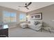 Bright living room with windows, comfortable seating, modern ceiling fan, and stylish decor at 2784 E Honeysuckle Pl, Chandler, AZ 85286