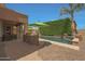 Patio area with stone outdoor grill, lounge chairs, and pool view with shrubbery for privacy at 2784 E Honeysuckle Pl, Chandler, AZ 85286