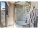 Well-lit bathroom with a glass door to shower/tub area and a glass sliding door accessing the outdoors at 2839 N 61St St, Scottsdale, AZ 85257
