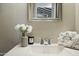 Elegant bathroom sink with decorative mirror, white towels, and a vase of white carnations at 2839 N 61St St, Scottsdale, AZ 85257