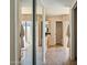 Bathroom hallway with tile floors, mirrored closet doors, and access to the vanity and toilet areas at 2839 N 61St St, Scottsdale, AZ 85257