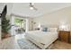 Bright bedroom with a king-sized bed, sliding glass doors to the patio, and a ceiling fan at 2839 N 61St St, Scottsdale, AZ 85257