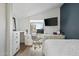 Bedroom featuring a white desk area with drawers and an adjacent work station with a mounted television at 2839 N 61St St, Scottsdale, AZ 85257