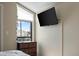 Bright bedroom features a mounted television, large window, and chest of drawers at 2839 N 61St St, Scottsdale, AZ 85257