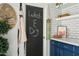 Stylish kitchen with floating shelves, white subway tile, and painted chalkboard door at 2839 N 61St St, Scottsdale, AZ 85257