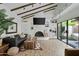 Inviting living room with vaulted ceilings, wood beams, a fireplace, and sliding glass doors to a peaceful patio at 2839 N 61St St, Scottsdale, AZ 85257