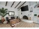 Cozy living room featuring a fireplace, vaulted ceilings with beams, and stylish decor, creating a warm ambiance at 2839 N 61St St, Scottsdale, AZ 85257