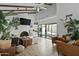 Bright living room boasts vaulted ceilings, wood beams, tiled fireplace, and sliding glass doors to a private patio at 2839 N 61St St, Scottsdale, AZ 85257